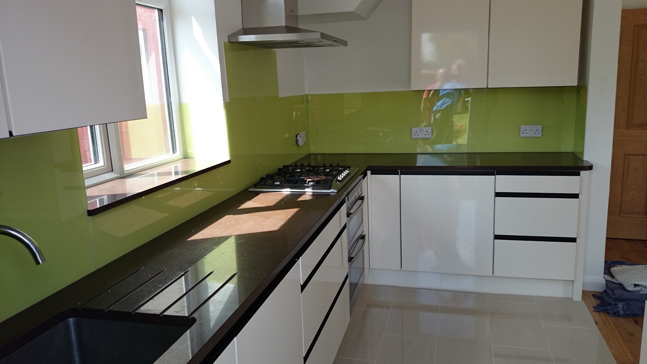Lime green glass kitchen splashback installed by Berkhamsted glaziers