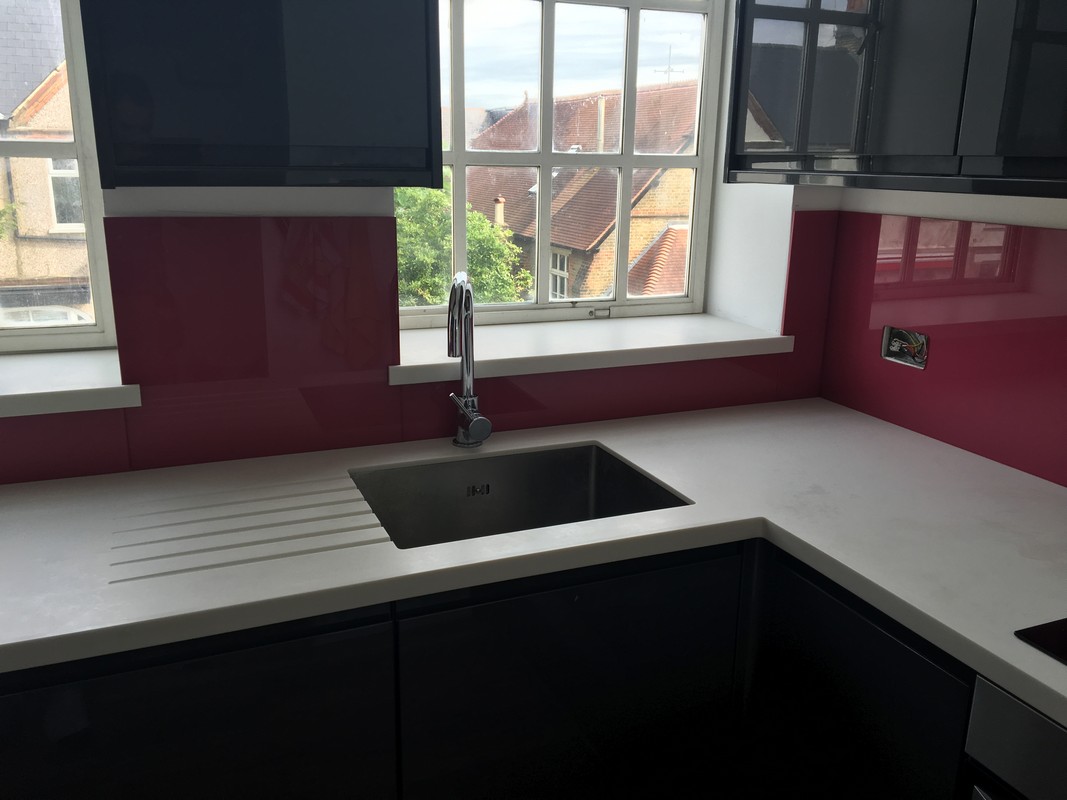 Deep plum coloured glass splashback in modern Berkhamsted kitchen